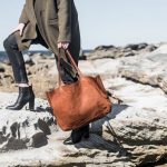 girl with black boots and jeans and brown tote leather bag