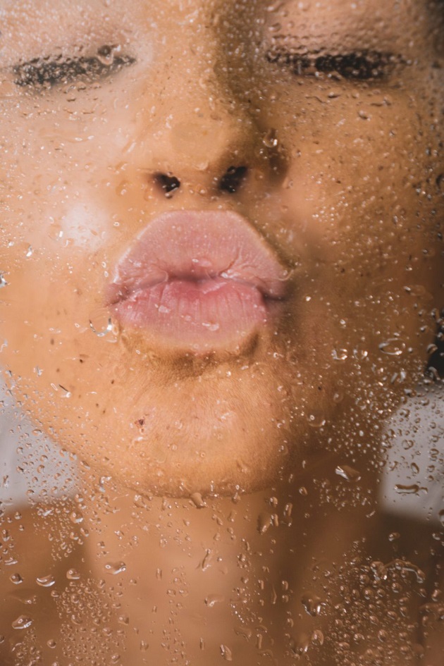 picture of a woman giving a kiss on a wet glass